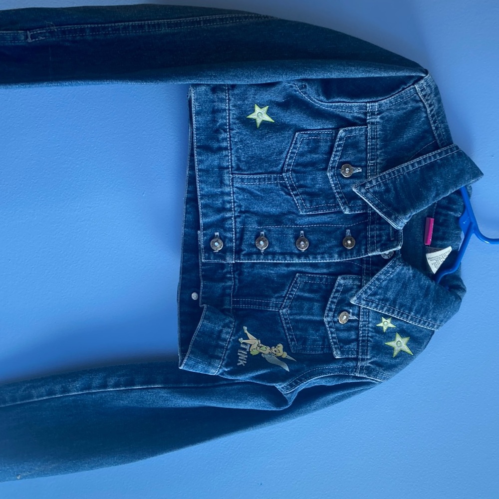 A half length, Jean jacket with Tinker Bell on it
